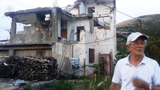 Albanian authorities used a World Bank-backed project to clear the way for a planned seaside resort, partly or completely tearing down 15 homes in the impoverished village of Jale. Andon Koka’s home was flattened, and half of his brother’s home (in background) was demolished. Besar Likmeta / BalkanInsight.com