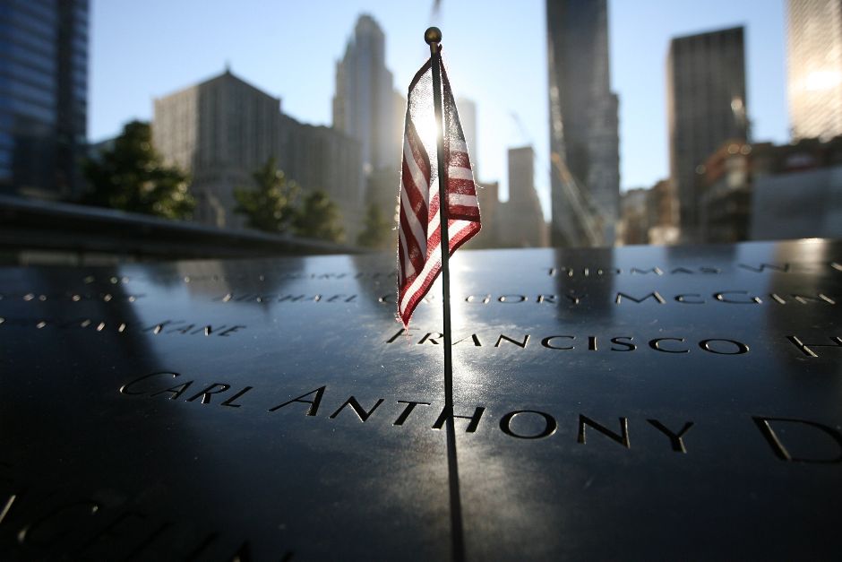 A small US flag stands at memorial of the north tower during observances on the eleventh anniversary of the attacks on the World Trade Center, on September 11, 2012 in New York. AFP PHOTO/CHris Pedota / POOLCHRIS PEDOTA/AFP/GettyImages
