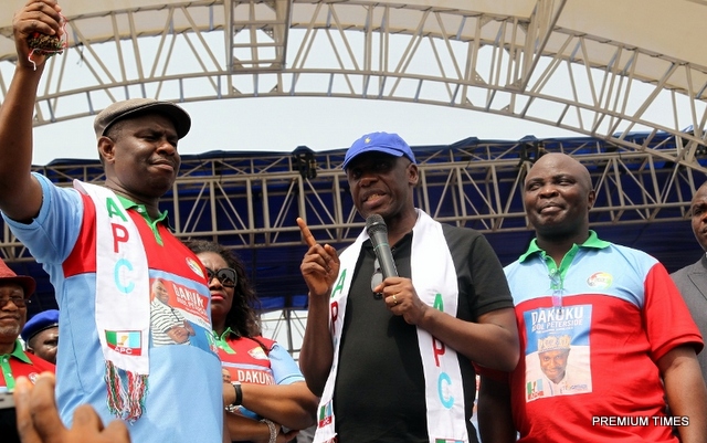 FILE: Former Rivers State Governor, Chibuike Rotimi Amaechi flanked by the All Progressives Congress Governorship Candidate in the State, Dakuku Peterside (left) and his running mate, Asita, at the State APC 2015 gubernatorial campaign flag off at the Liberation Stadium, Port Harcourt.)