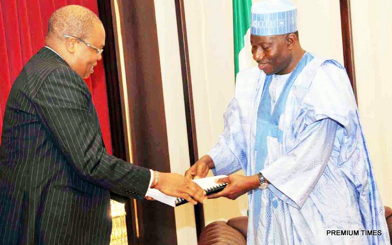President Goodluck Jonathan (R) receiving The Forensic Audited Report of Finances in NNPC from the Country Senior Partner, Pricewaterhousecoopers (Pwc), Mr Uyi Akpata, In Abuja
