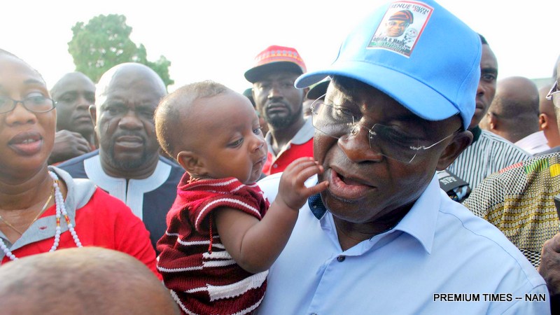 PIC. 1. FORMER SENATE PRESIDENT, SEN. DAVID MARK, CARRYING A BABY DURING HIS ASSESSMENT VISITS TO APA IDPS CAMP AND COMMUNITIES 

RECENTLY ATTACKED BY HERDSMEN IN AGATU, BENUE ON SUNDAY (13/3/16)
2257/13/3/2016/HB/NAN