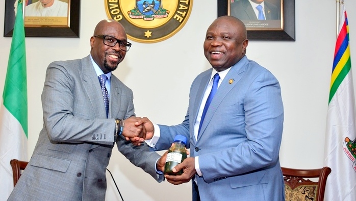 Lagos State Governor, Mr. Akinwunmi Ambode (right), receiving a sample of the Crude Oil discovered in the State by the Group Managing Director, Tunde Folawiyo Petroleum Company Limited, Mr. Tunde Folawiyo 
Photo: Lagos State government