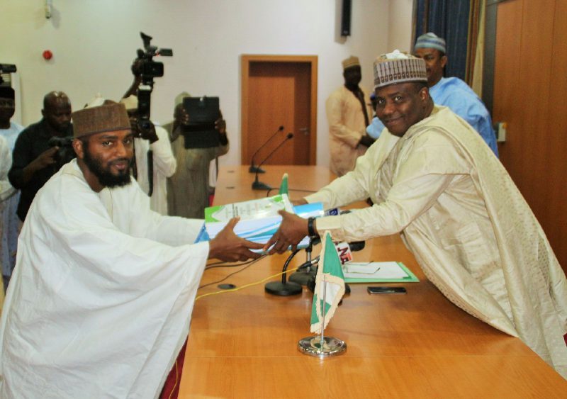Chairman of the Sokoto Government's schools needs assessment committee,  Shadi Sabeh, presenting the report of their committee to Governor Aminu Tambuwal. 