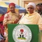 Aisha Buhari as she delivers speech using a lectern with her official seal. [Photo credit: ICIR]