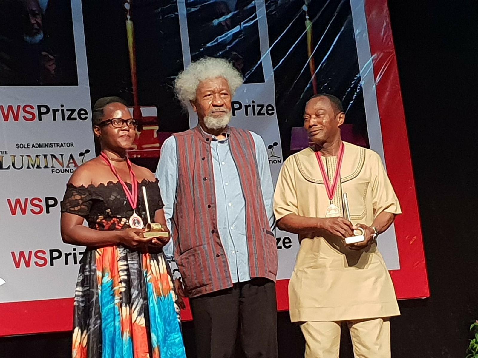 Harriet Anena (L) with renowned African author, Wole Soyinka (C) after winning the prize in Nigeria Credit-softpowernews