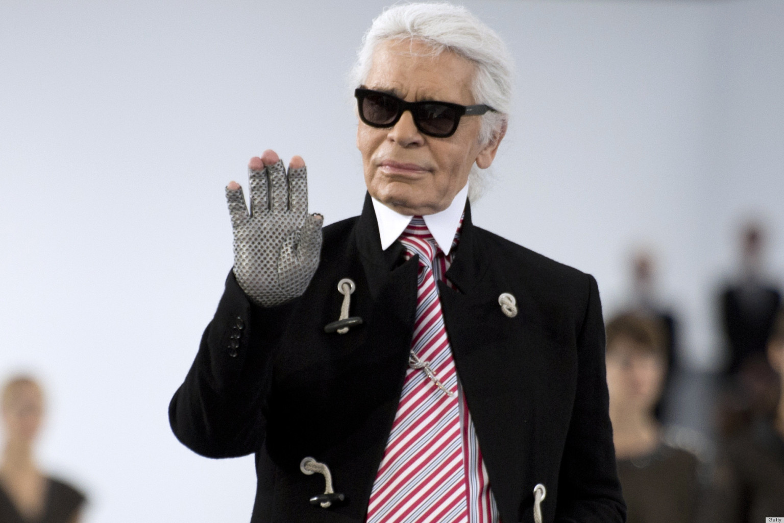 German fashion designer Karl Lagerfeld for Chanel acknowledges the public at the end of the Spring/Summer 2013 ready-to-wear collection show on October 2, 2012 at the Grand Palais in Paris. AFP PHOTO/MARTIN BUREAU (Photo credit should read MARTIN BUREAU/AFP/GettyImages)