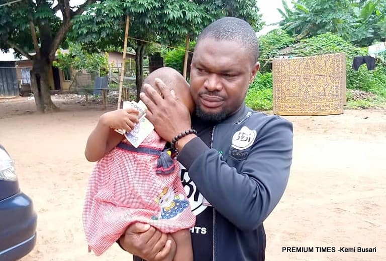 Mr Gwamnishu Harrison, the head of Behind Bars Rights Foundation, holding the two-year-old rape victim