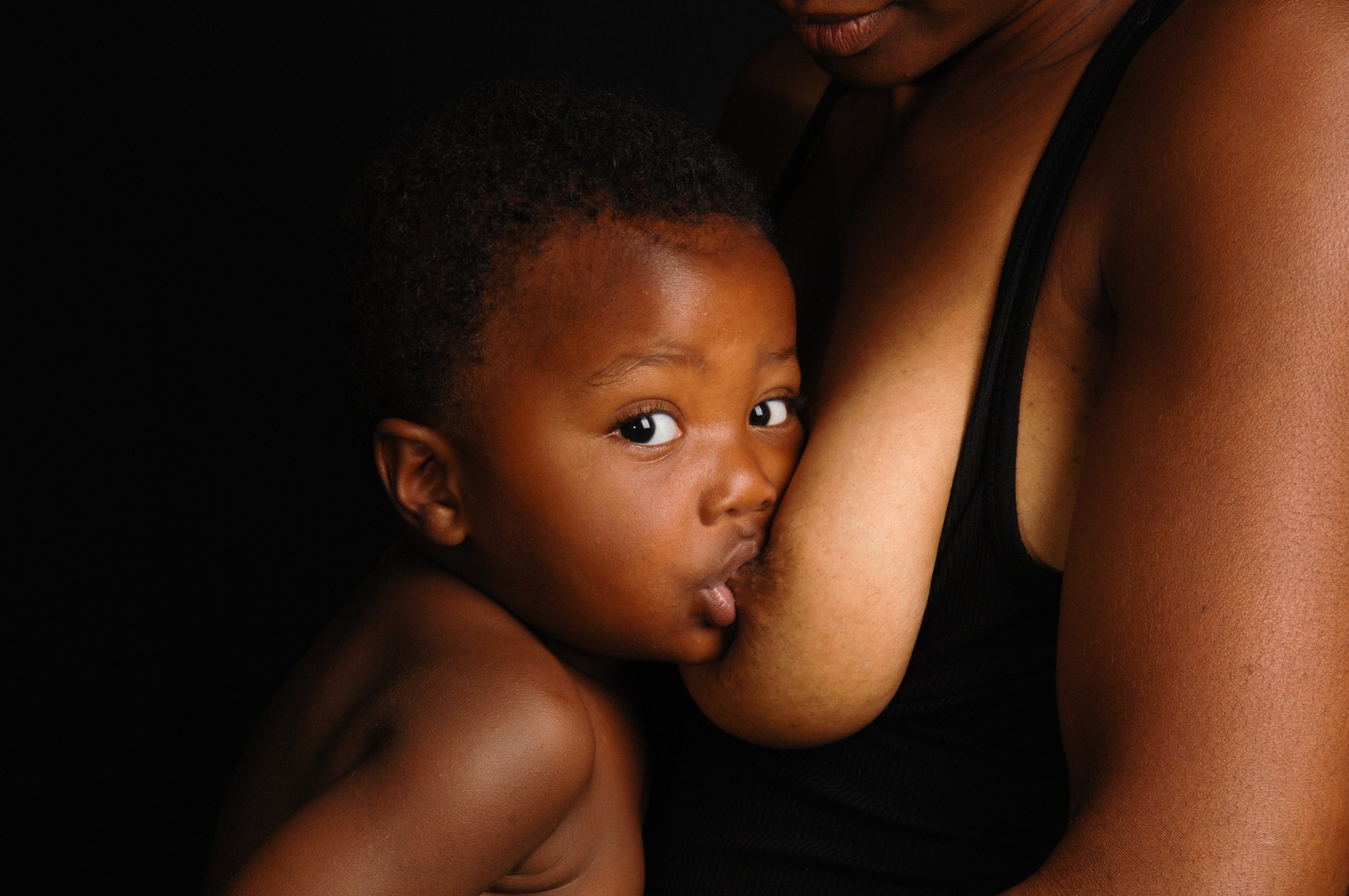 A woman breastfeeding her child. [PHOTO CREDIT: Mama Glow]