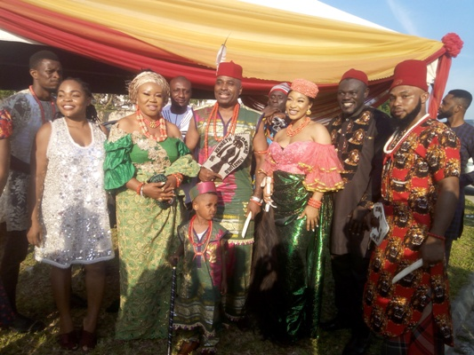 Nollywood stars Kenneth Okonkwo and Tonto Dikeh flanked by relatives and well-wishers at the Nollywood New Yam Festival in Abuja