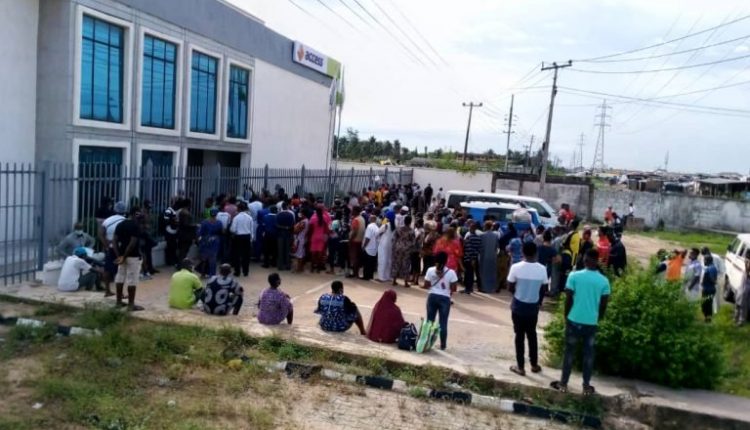 Nigerians queuing up to access the bank.