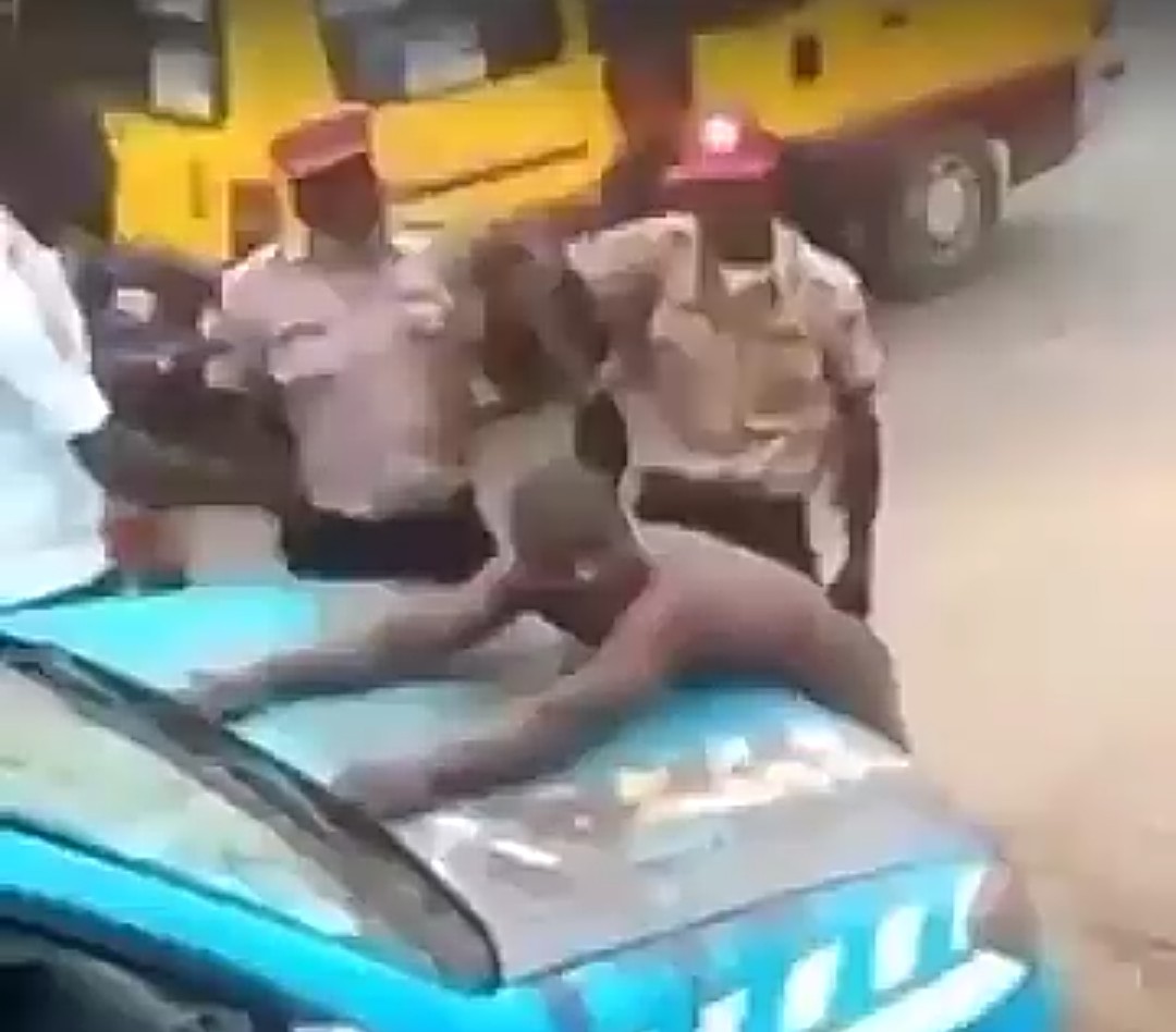 Incident scene of the angry man scantily dressed, standing on the bonnet of the FRSC’s patrol vehicle.