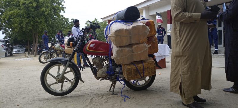 jars of fuel on motorcycle. of suspected Boko Haram 'suppliers'