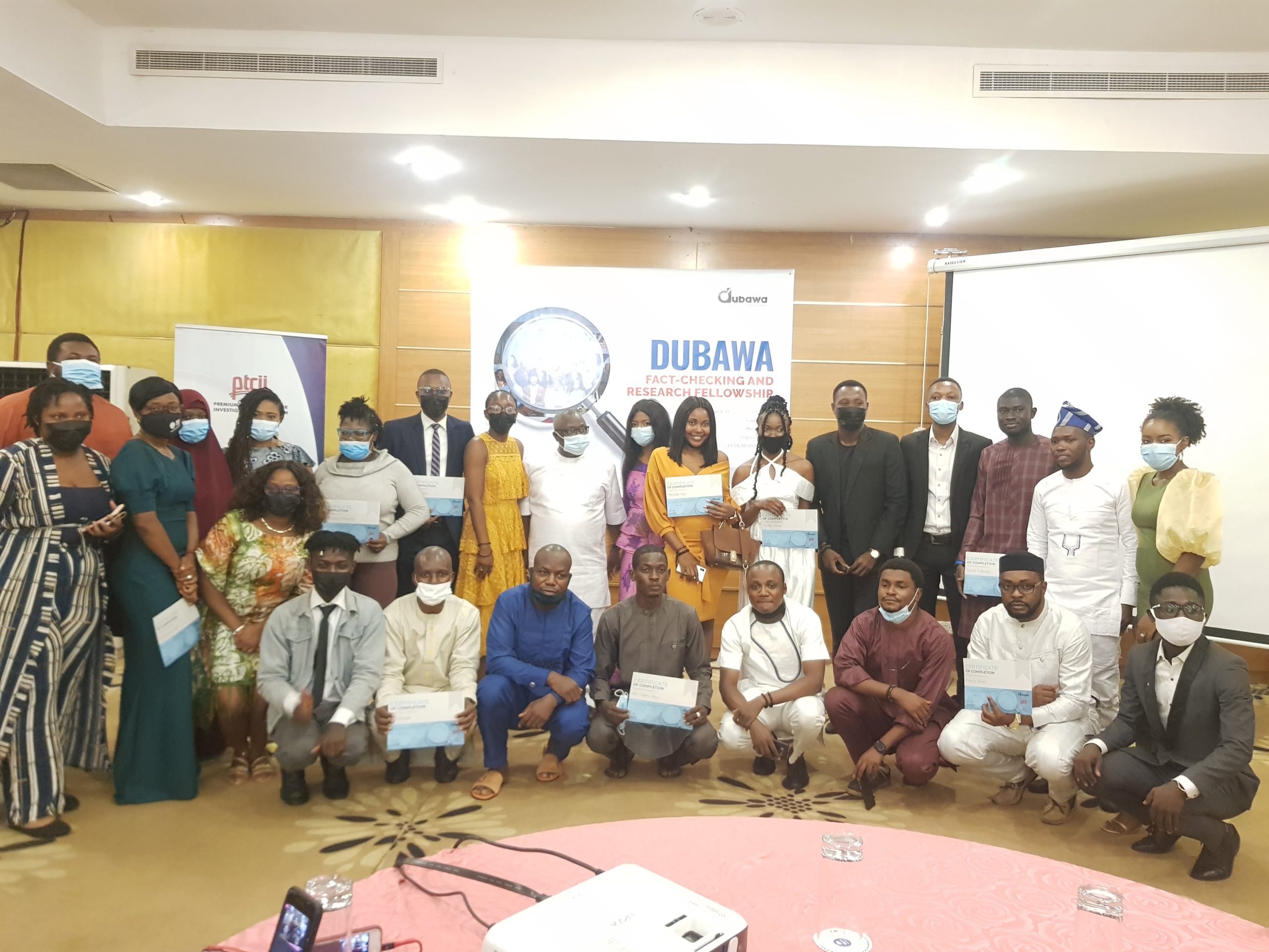 A cross section of the Dubawa 2020 fact-checking fellows flanked by the Dubawa and PTCIJ teams.