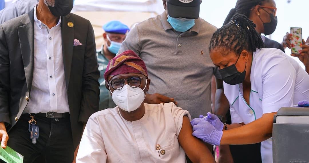 Lagos State Governor and the Incident commander, Mr. Babajide Sanwo-Olu receives COVID-19 Vaccination while the Commissioner for Health, Prof. Akin Abayomi (left), watches, at the Infectious Disease Hospital (IDH), Yaba, on Friday, March 12, 2021.
