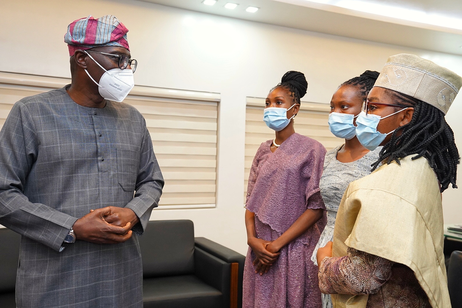 Lagos State Governor, Mr. Babajide Sanwo-Olu (left) interacts with winner of the 2018/2019 spelling Bee competition & the One-Day Governor, Miss Eniola Ajala of Lafiaji Senior High School (right), her cabinet members, Commissioner for Education, Miss Eunice Adedotun and One-Day Deputy Governor, Miss Grace Ikhariale of TinCan Island Senior High School, during the One-Day Governor’s visit to the Lagos House, Alausa, Ikeja, on Friday, March 26, 2021.
