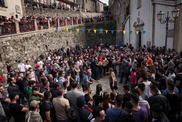 The faithful dancing in the typical Calabrian tradition during the celebrations for Santa Maria di Polsi, in the square in front of the sanctuary. [Credit: Michele Amoruso/Pacific Press/Alamy]