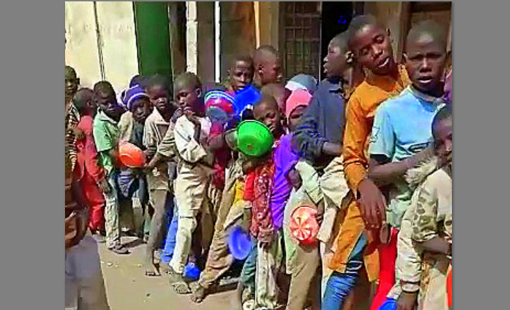 Some out-of-school children queueing for food.