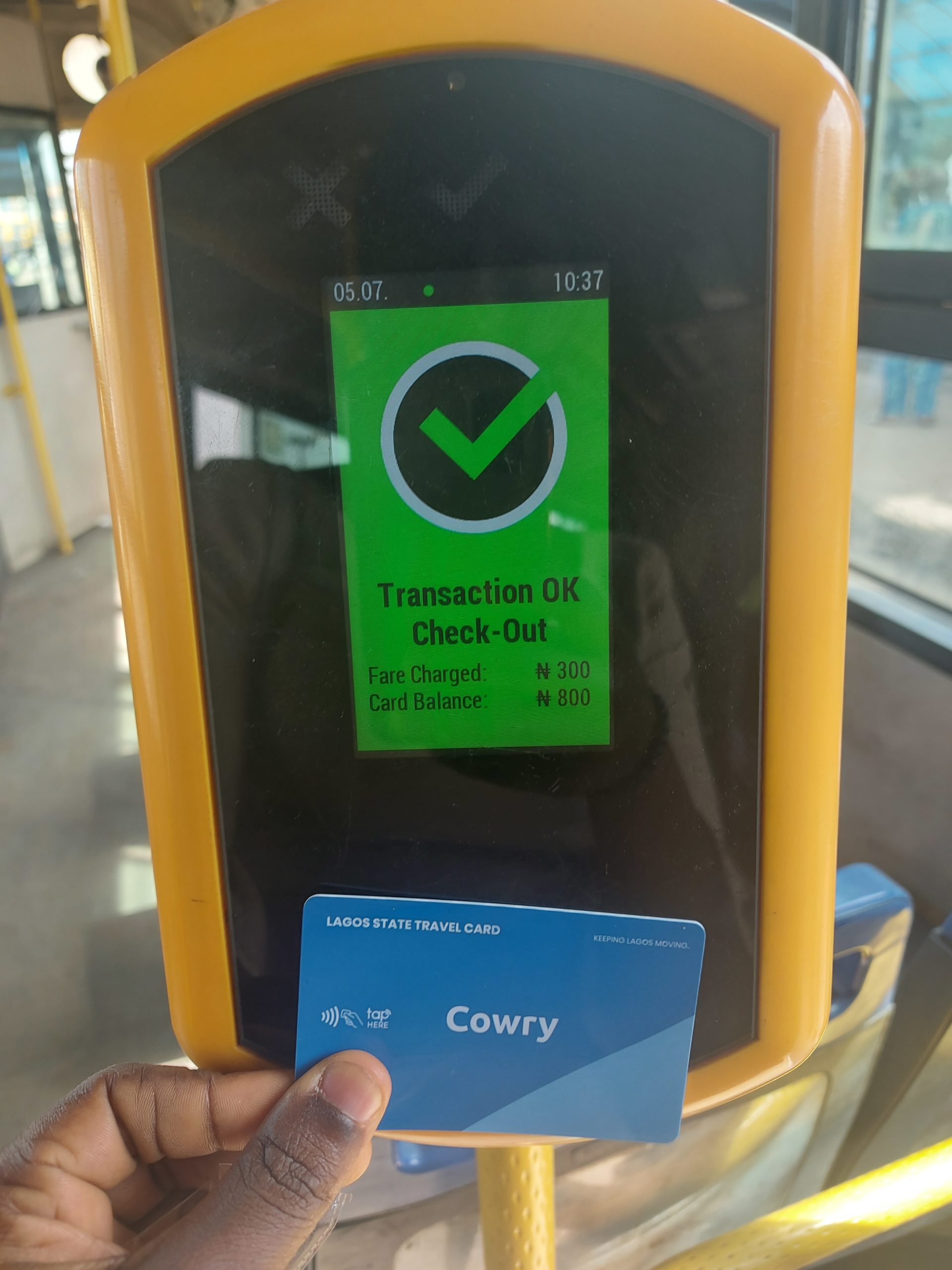 The cowry card validator in a BRT bus showing a successful payment.
