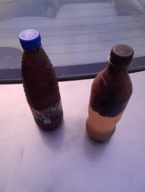 Photo: Nengi James' hydrocarbon polluted water samples, which he hopes to use in court to press for cleanup. Credit: Taiwo Adebayo/PT