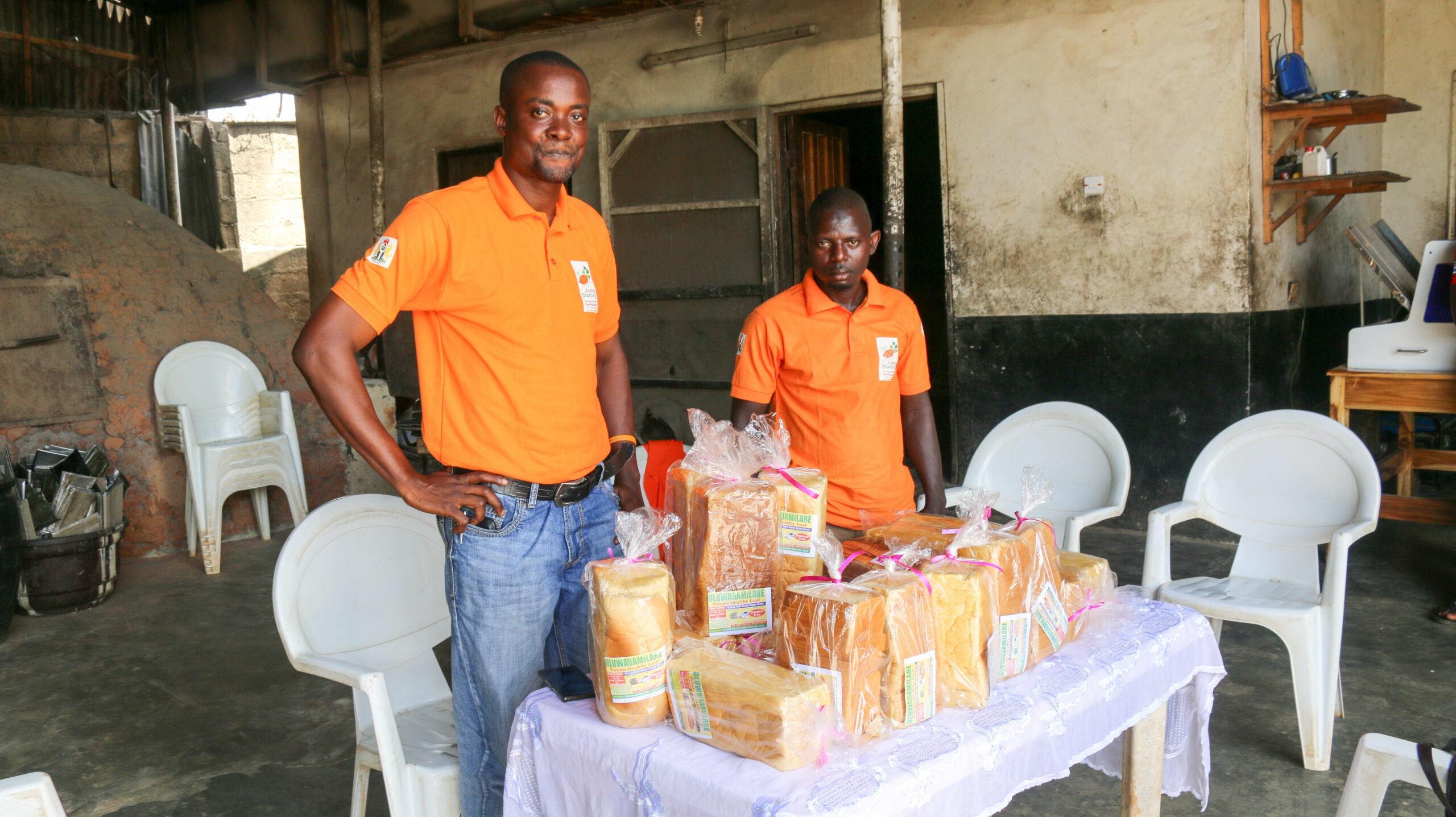 Fatai Ganiyu (left) displaying OFSP bread loaves made BY his bakery (PHOTO CREDIT: CIP)