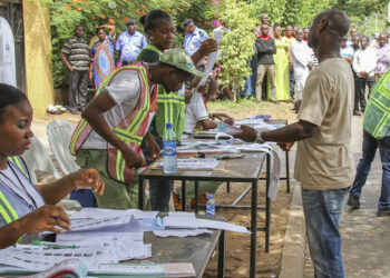 FILE PHOTO: INEC adhoc staff (corp members) attending to a voter during the just concluded presidential election in Ogun