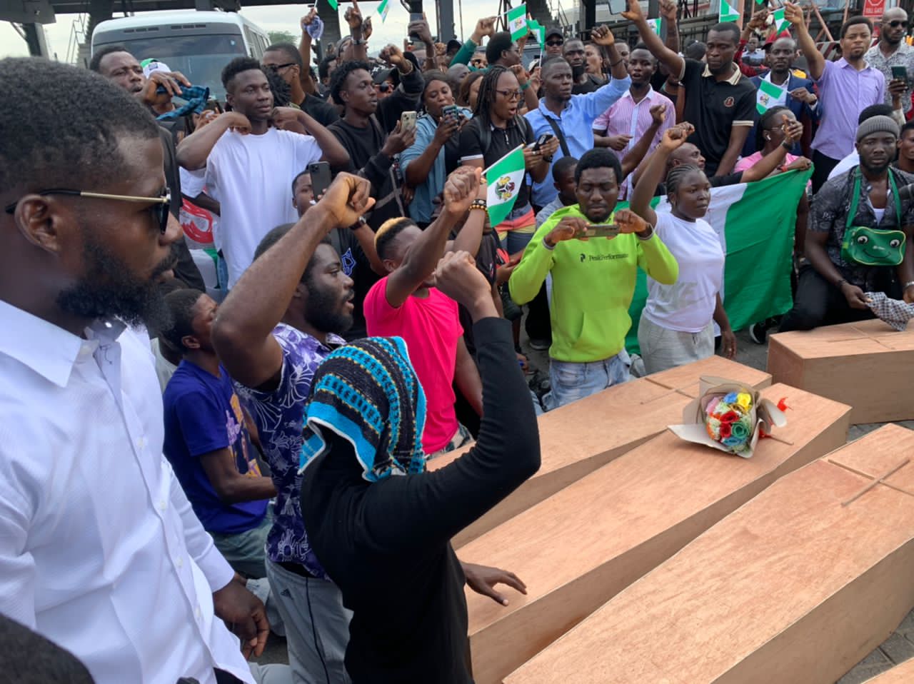 Young Nigerians carry coffins to protest at the Lekki tollgate