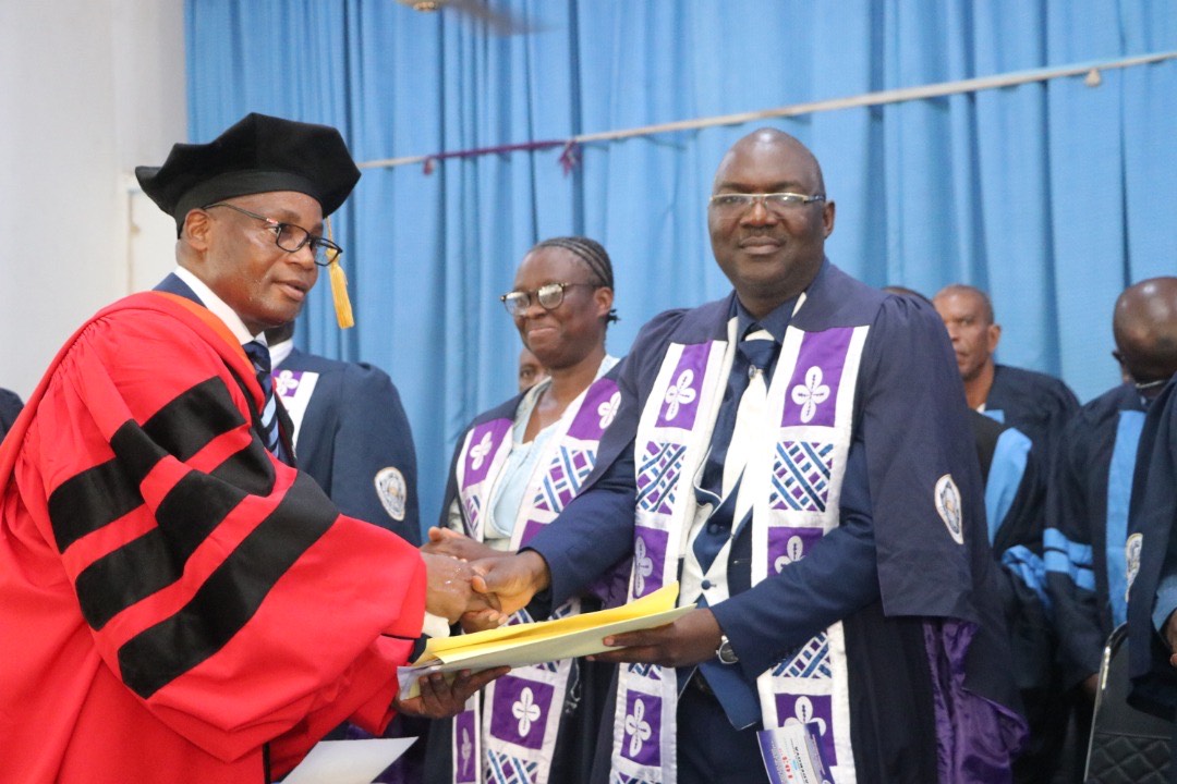 Charles Adekoya, presenting a copy of his lecture to the Vice-Chancellor of OOU, Ayodeji Agboola.