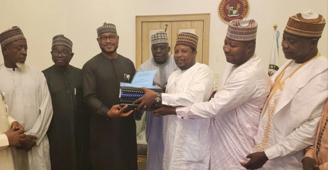 Governor Dauda Lawal receiving the report from Musa Mallaha in Gusau on Friday. Pic: Zamfara Government House.
