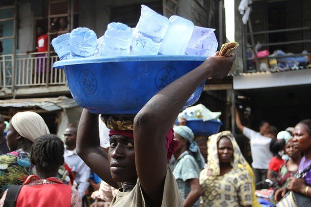 A teen hawking bottled/sachet water on the street of Lagos